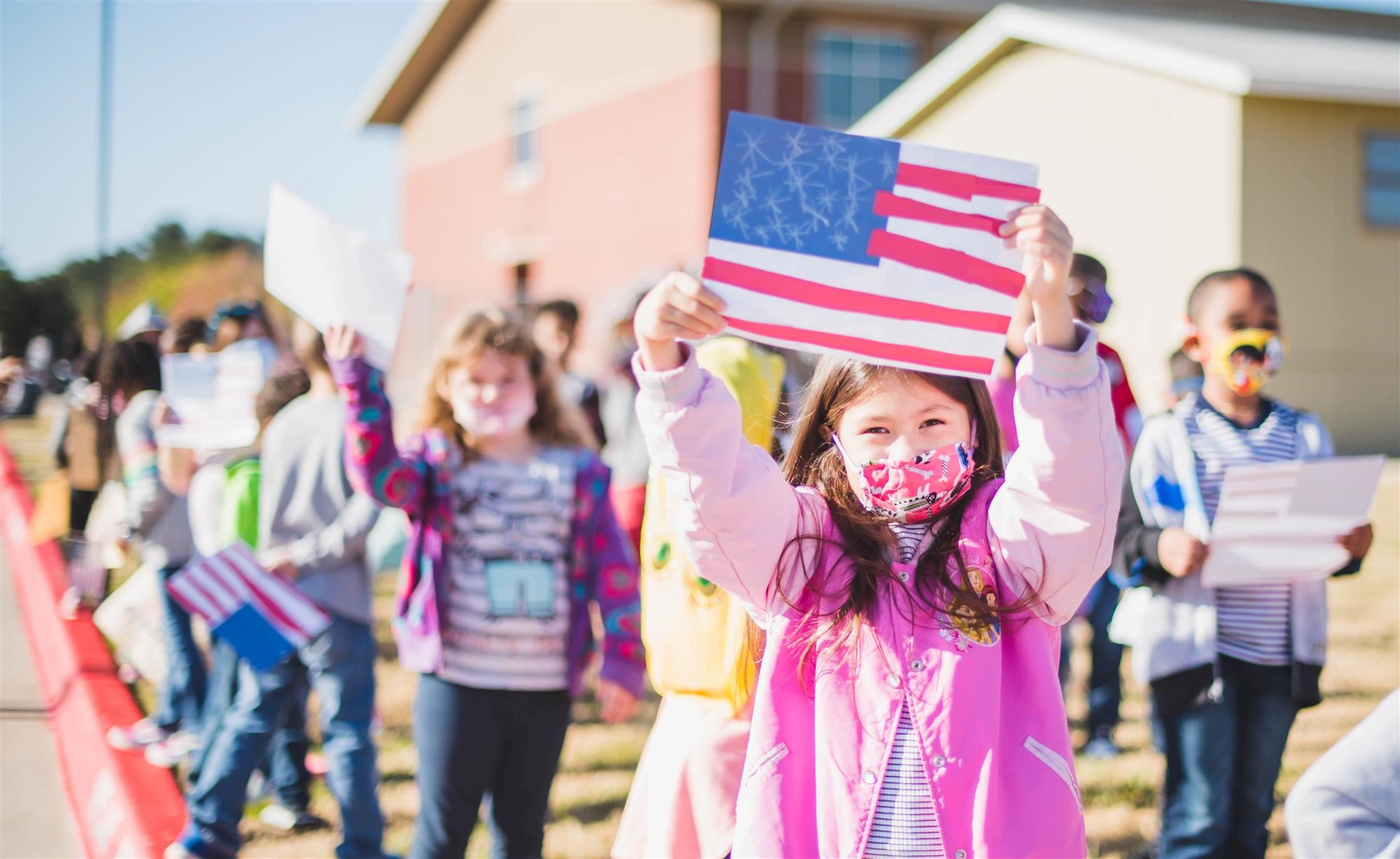 Students hold up flag.  