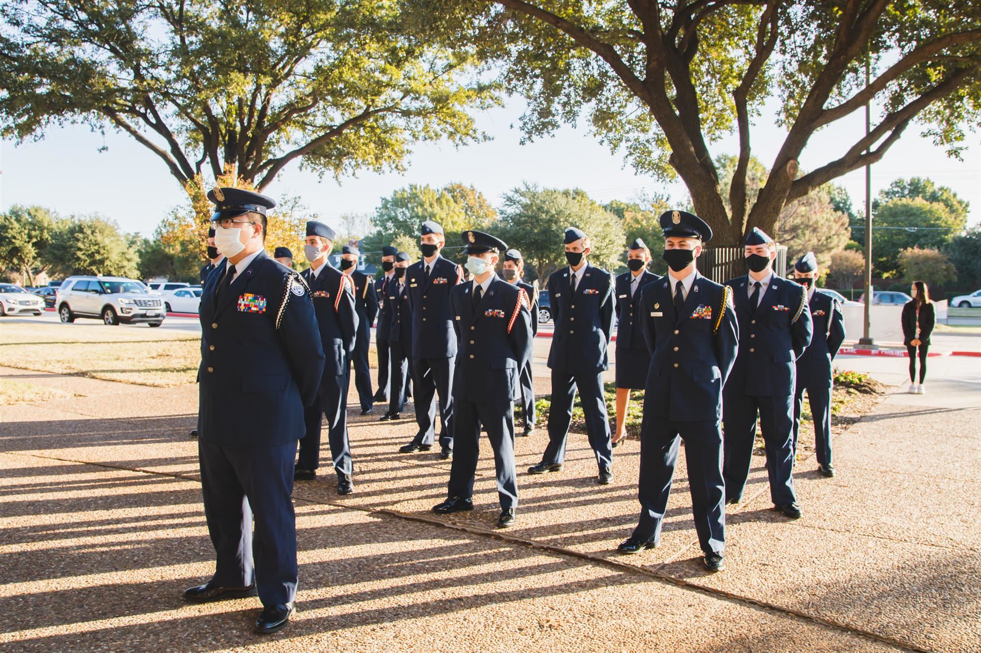 Students stand at Veterans Day ceremony. 