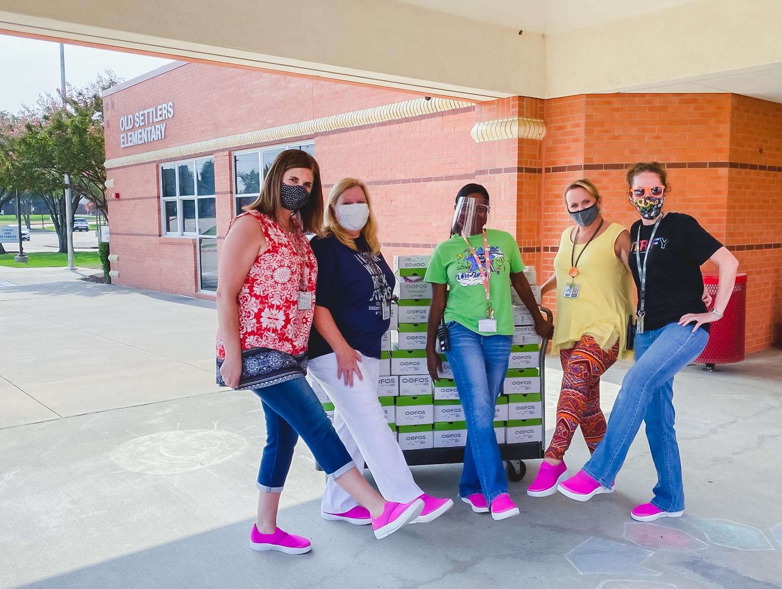 Old Settlers staff pose with their new OOFOS shoes on their feet. 2020 