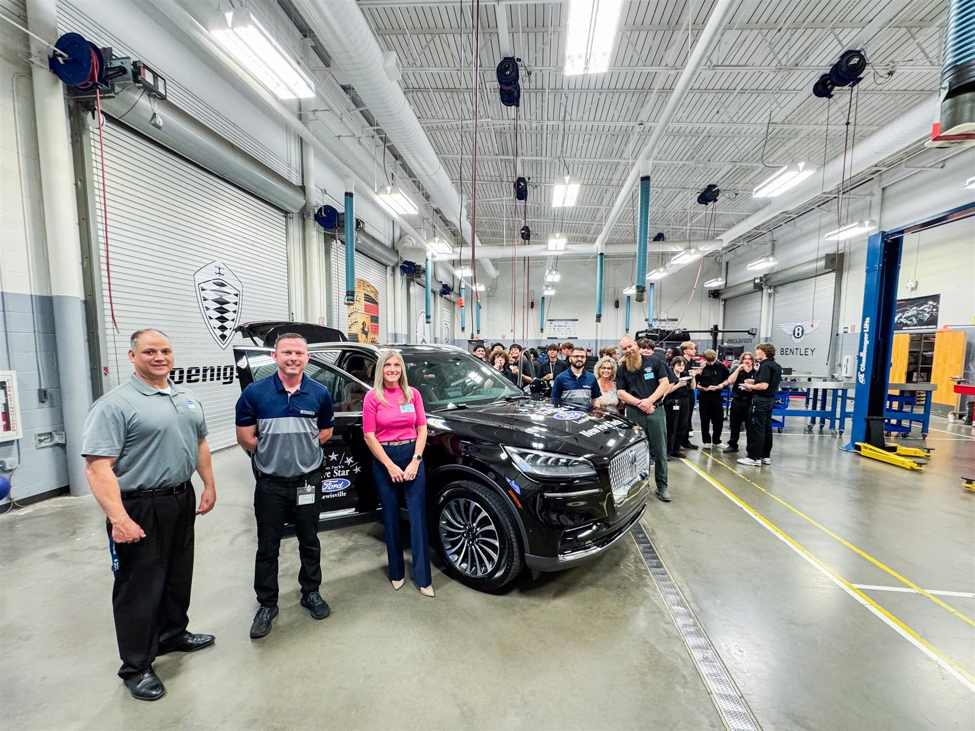 TECC East students ant staff pose with Ford Motor Company employees and accept new Lincoln Aviator donation. May 2024