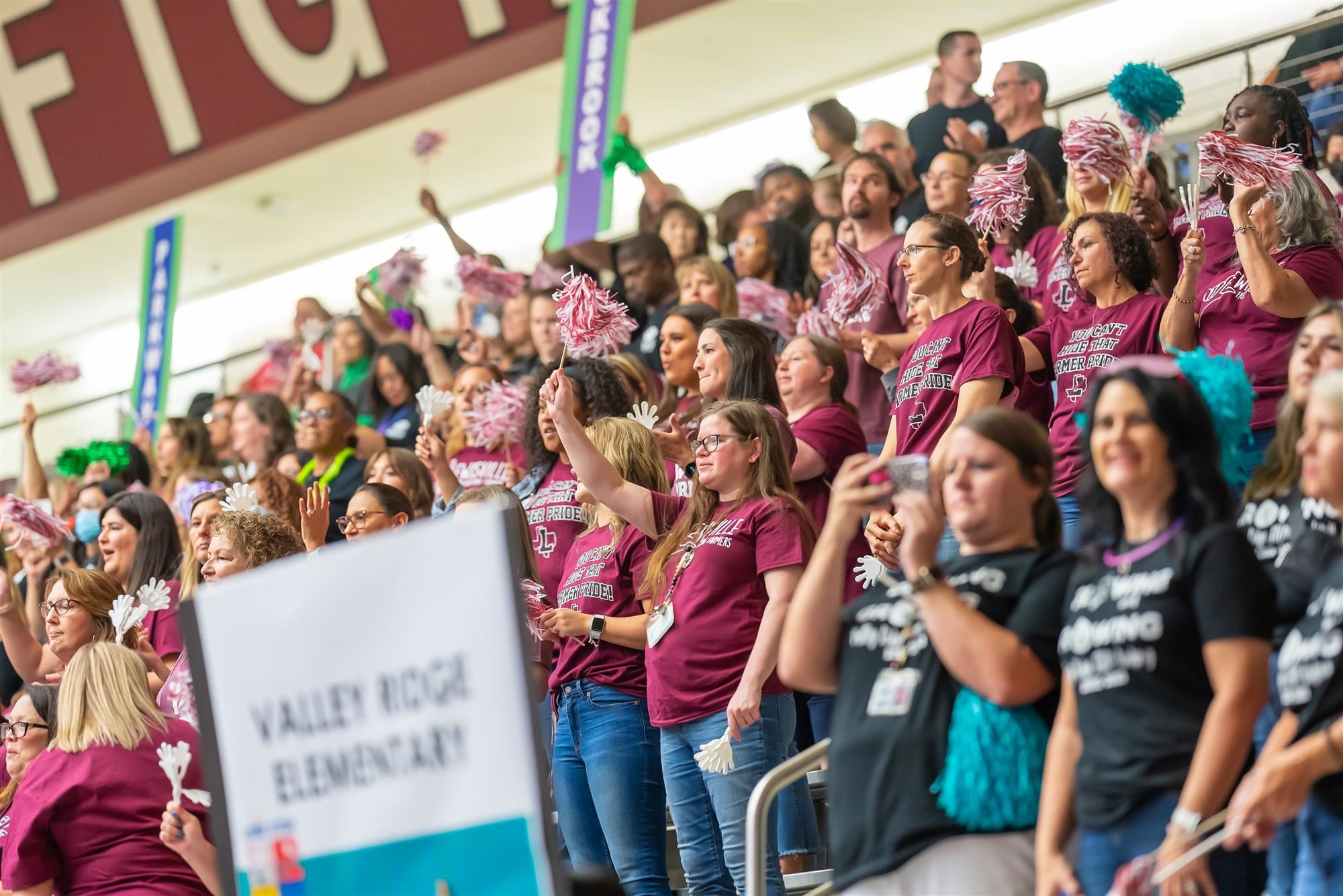 Teachers from Southridge Elementary cheer in the stands