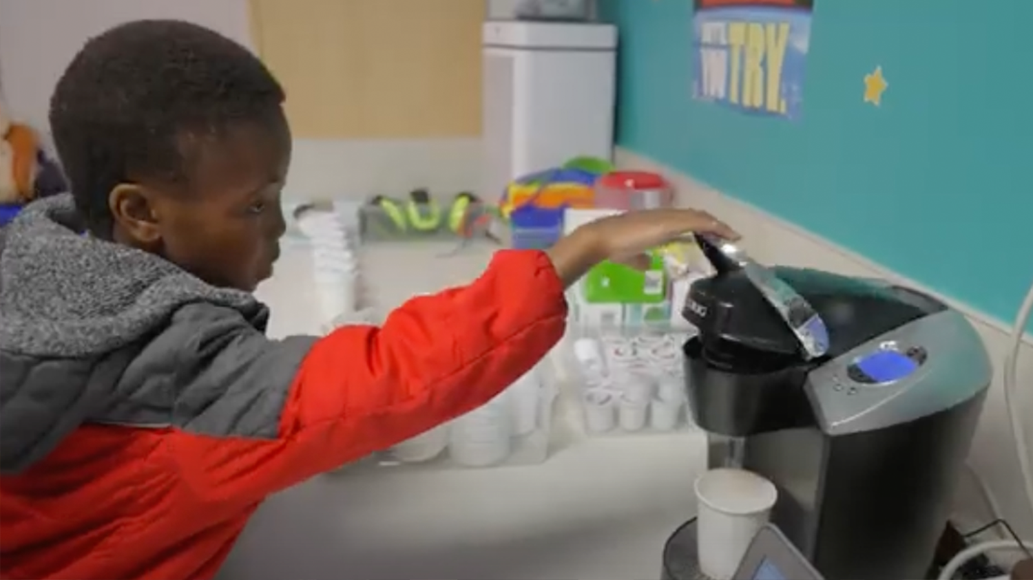  Young boy brewing coffee