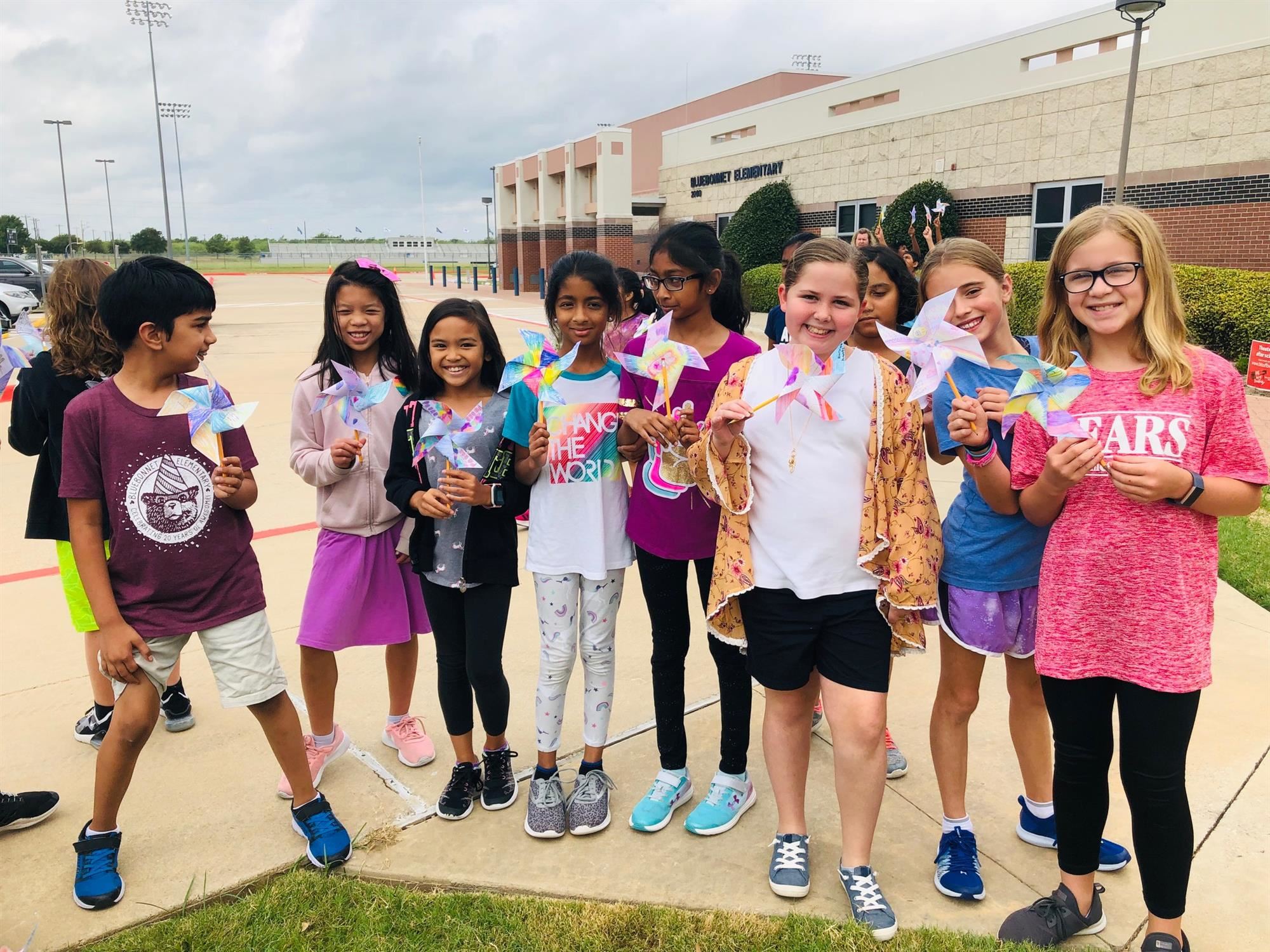 Bluebonnet elementary students pose with their pinwheels for peace outside of school. 2019 