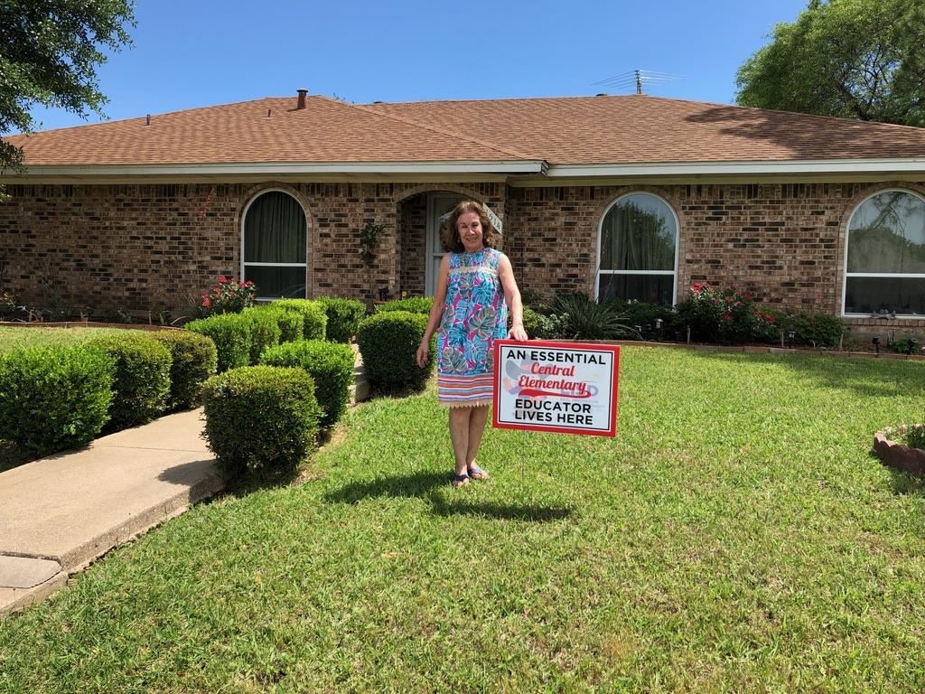 Central ES teacher receives a yard sign for Teacher Appreciation Week. 