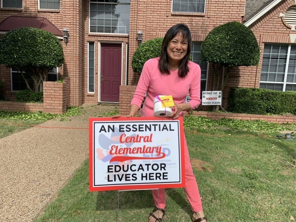 Central ES teacher receives a yard sign for Teacher Appreciation Week. 