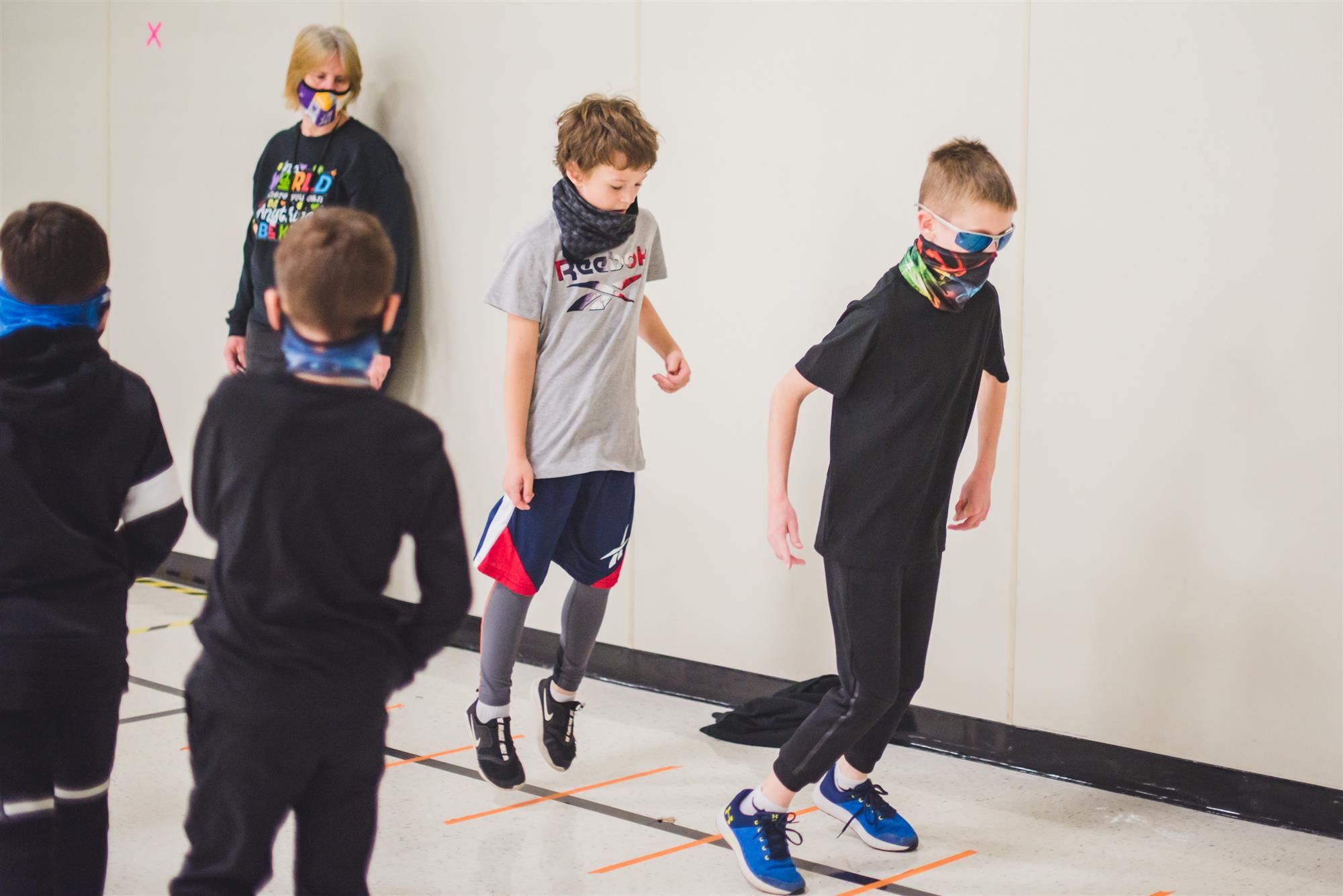 Students participate in hopscotch 