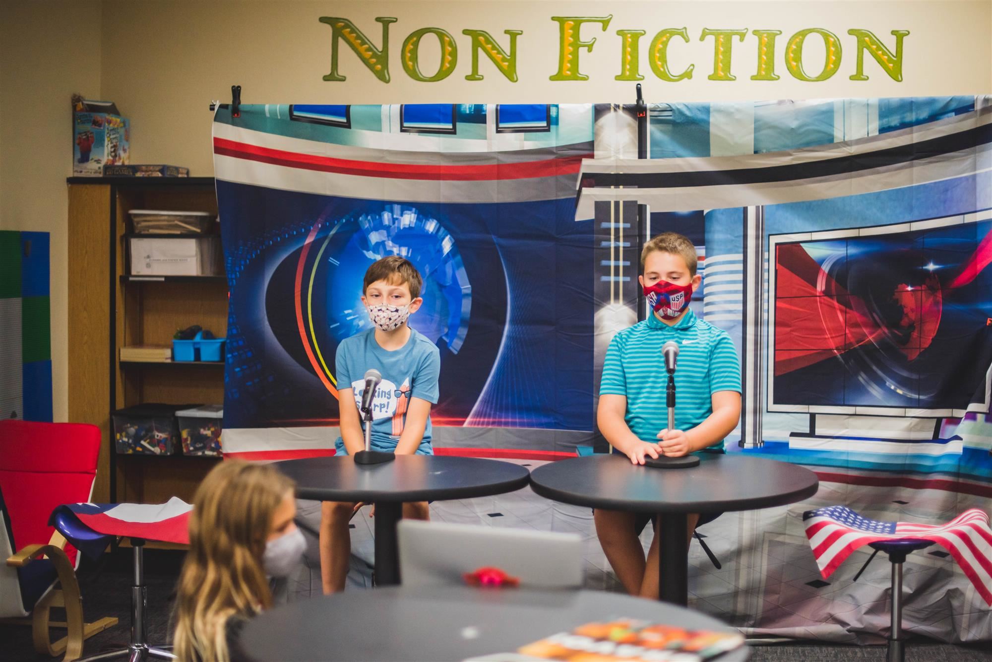 Two show anchors give morning announcements 