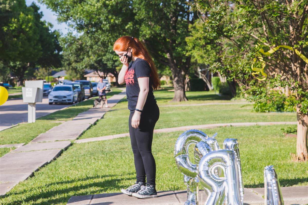 Elizabeth Harris stands outside her home, surprised to see everyone gathering in front of her home. 