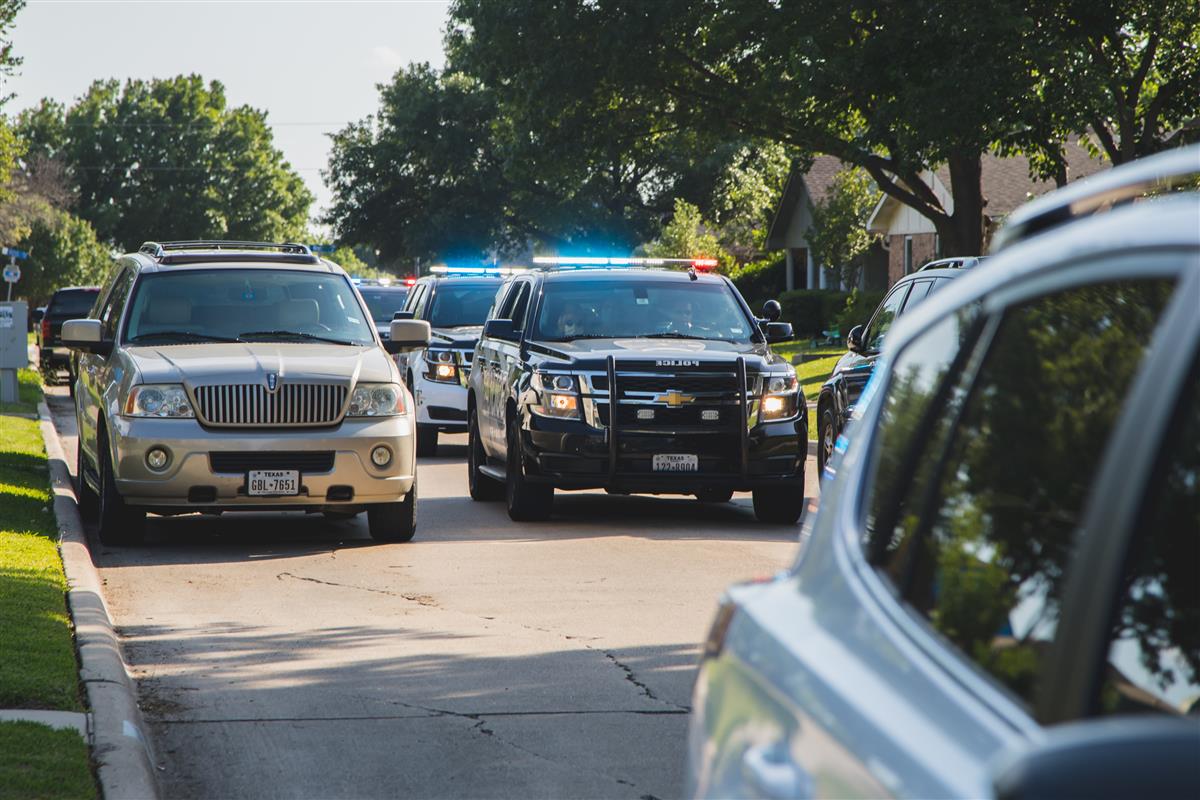 TCPD drives down a street. 