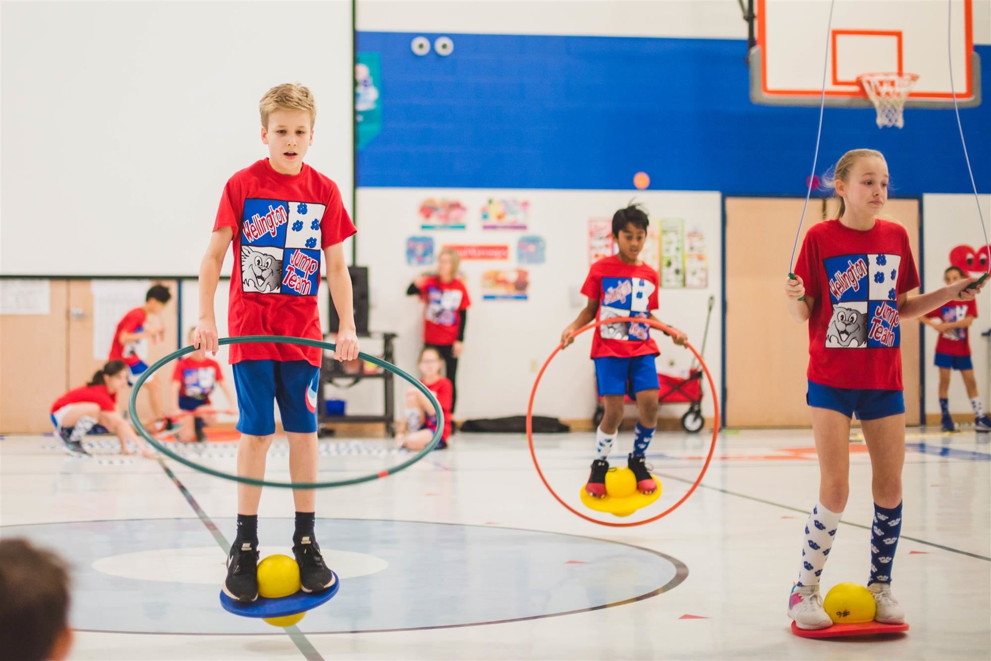 Student jump with hula hoops 