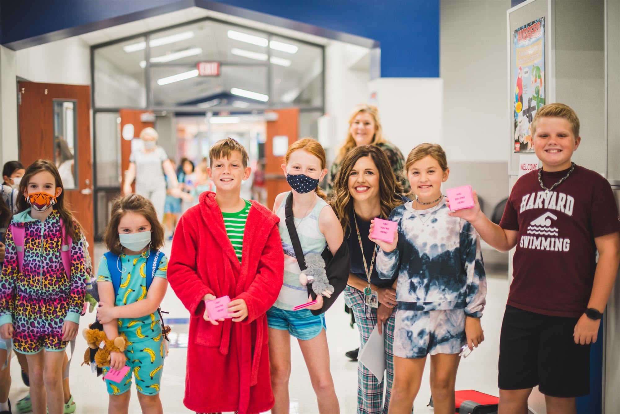 Students dressed in pajamas stand in hallway