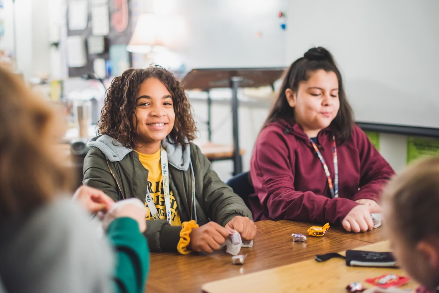 Students smile in desks 