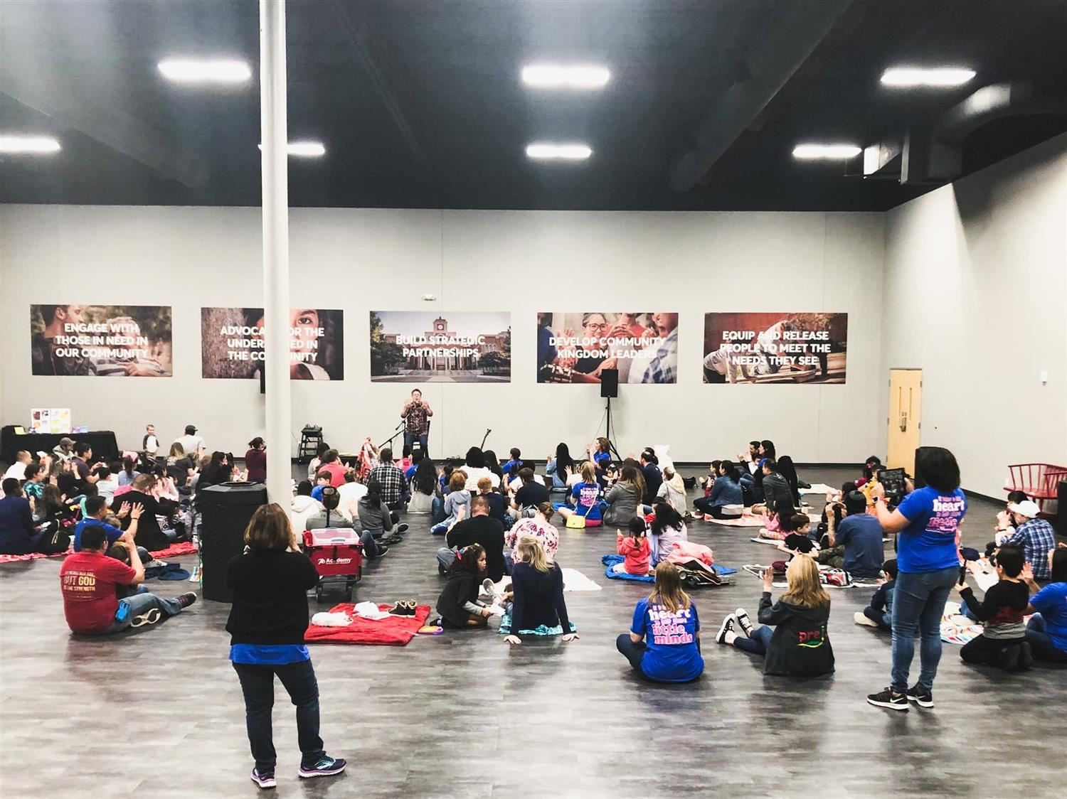 students and parents listen to concert performance 