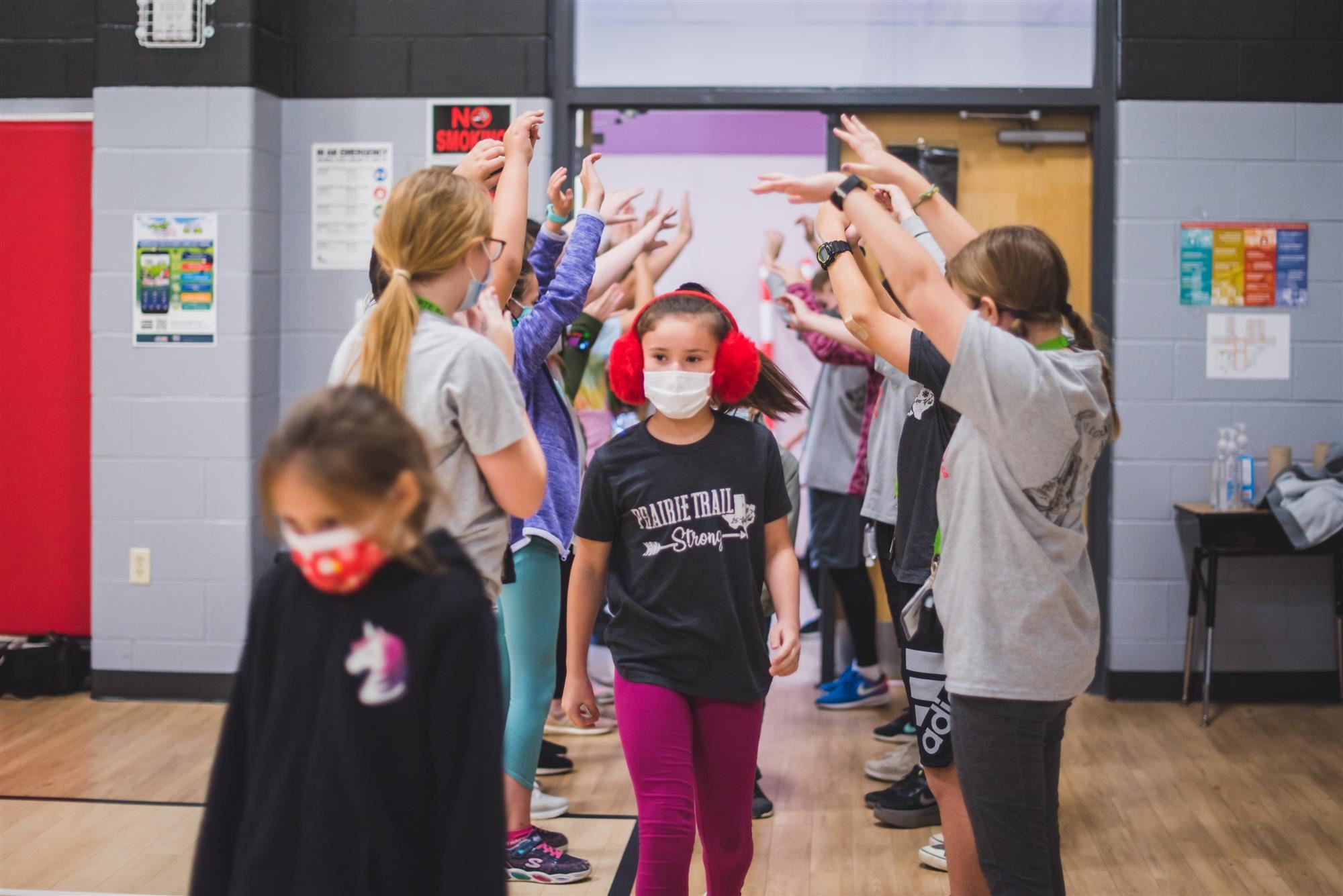 5th Grade Students welcome younger students into the gym 