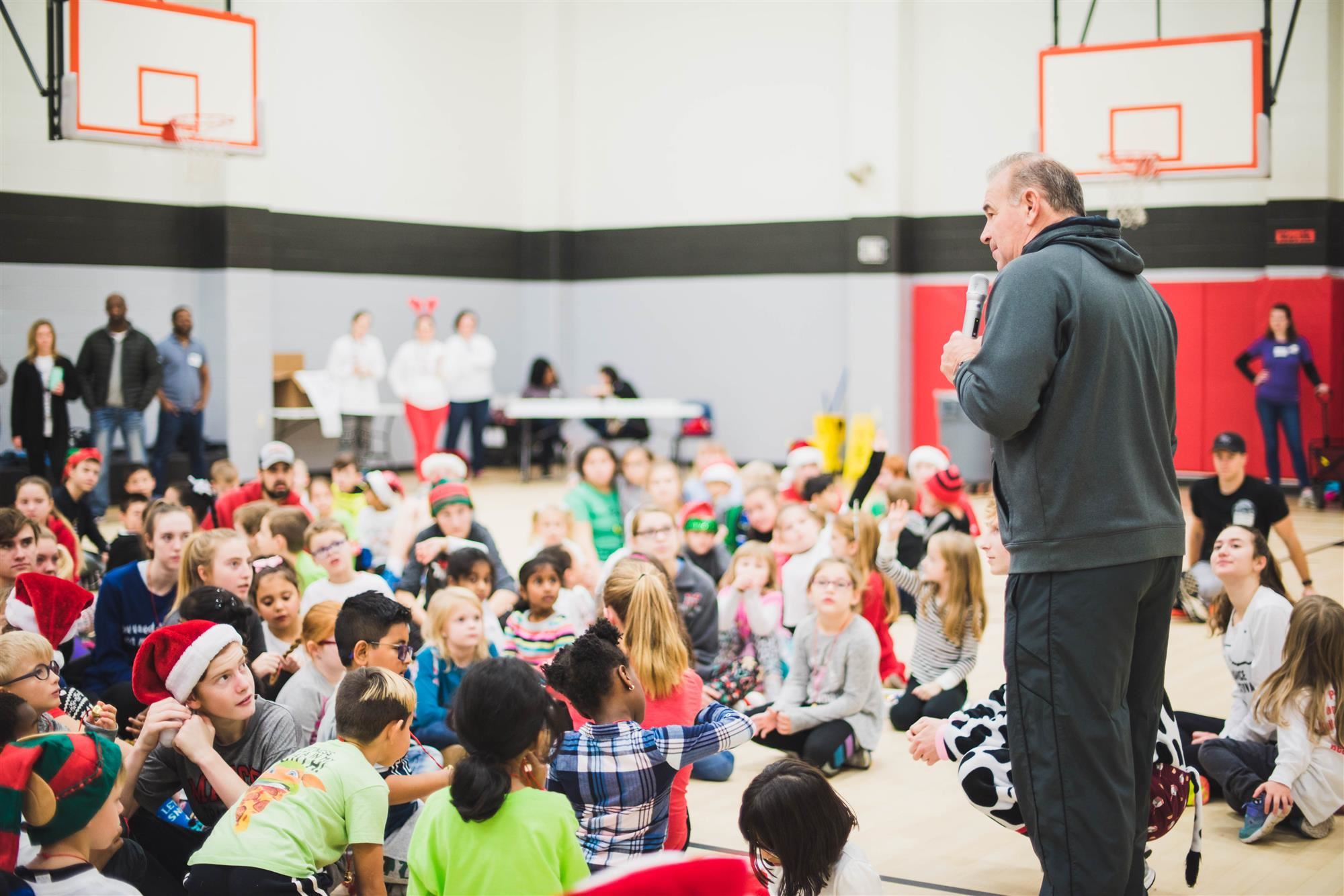 Coach T speaks to students at Jingle Bell Jog, 2018 