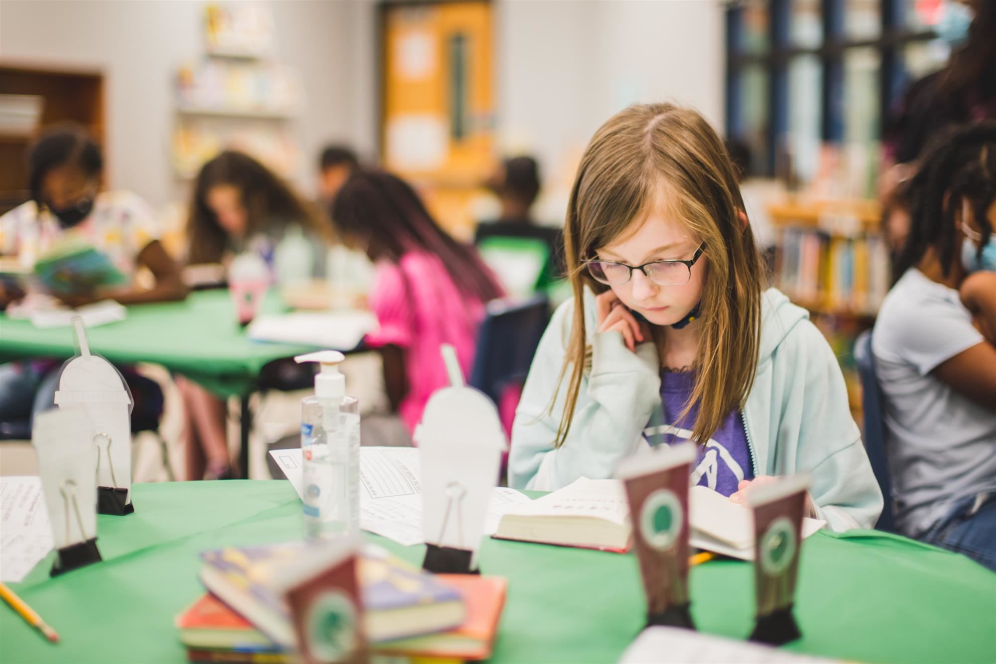 Students reads book. 
