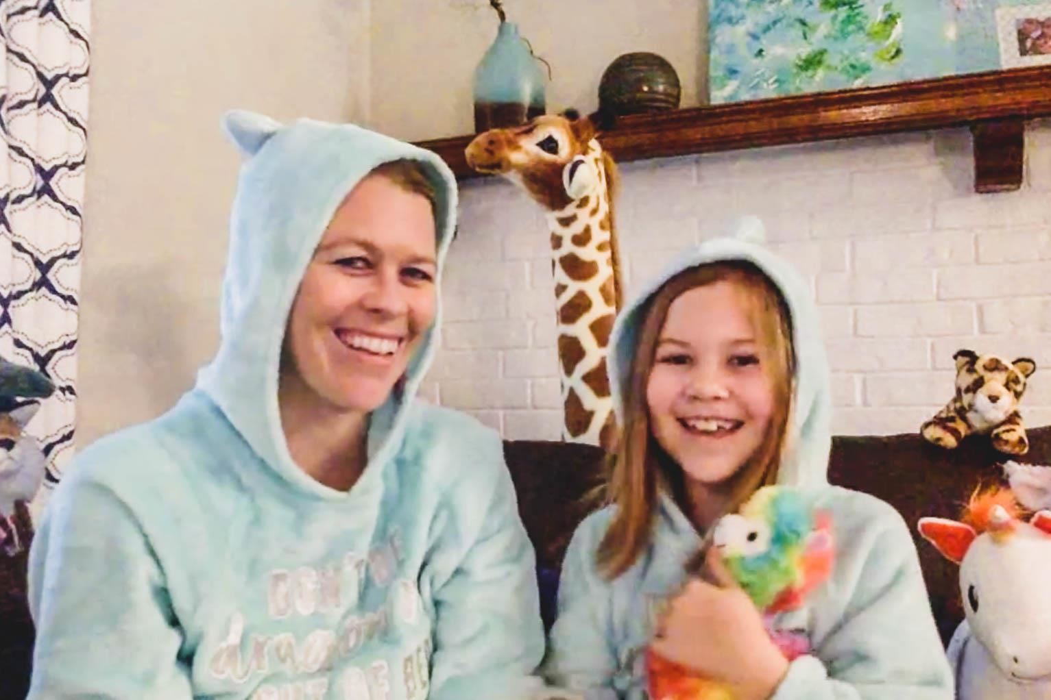 teacher and child wear matching unicorn pajamas 