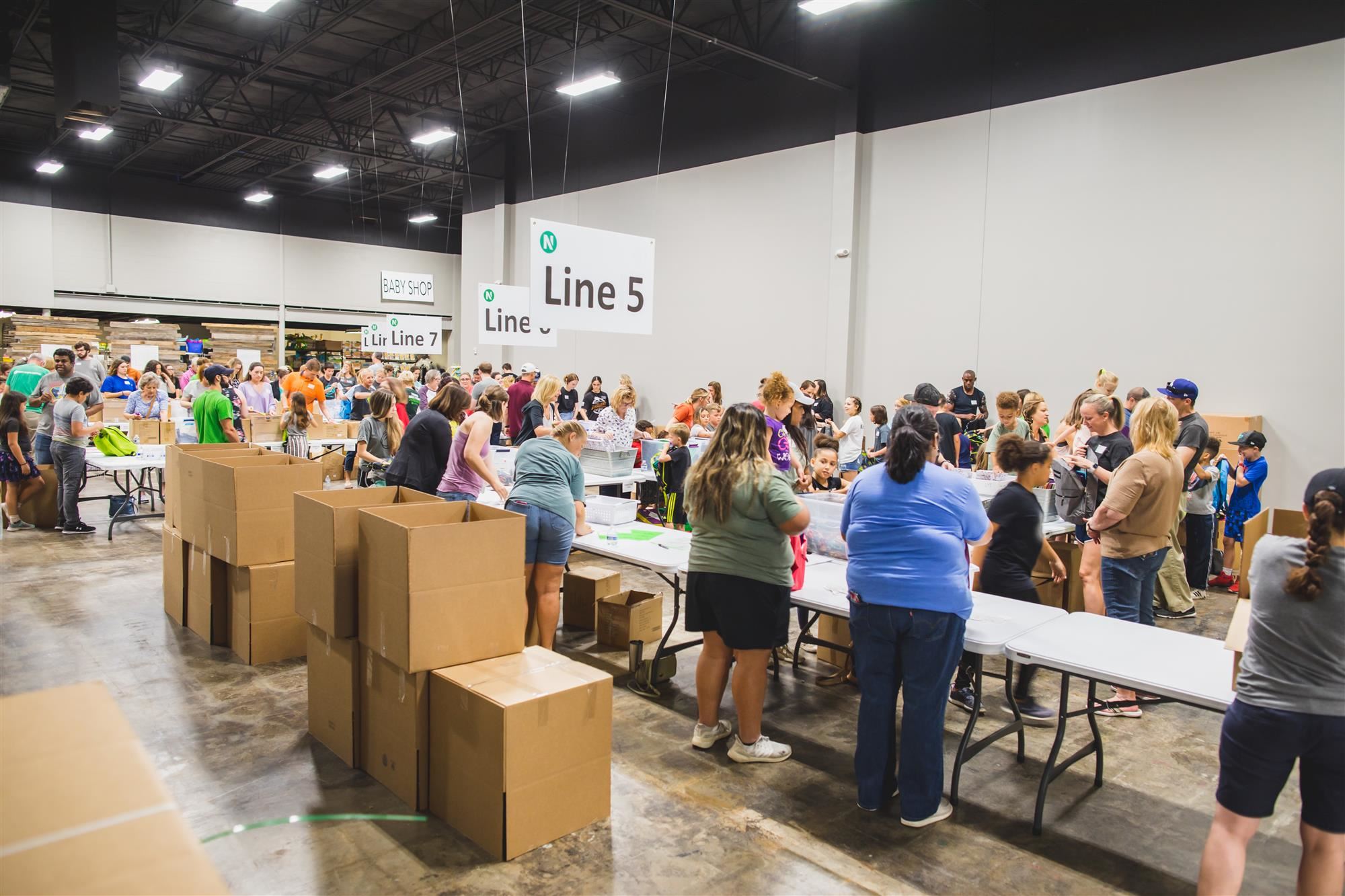 Volunteers stuff 4,000 backpacks with supplies.