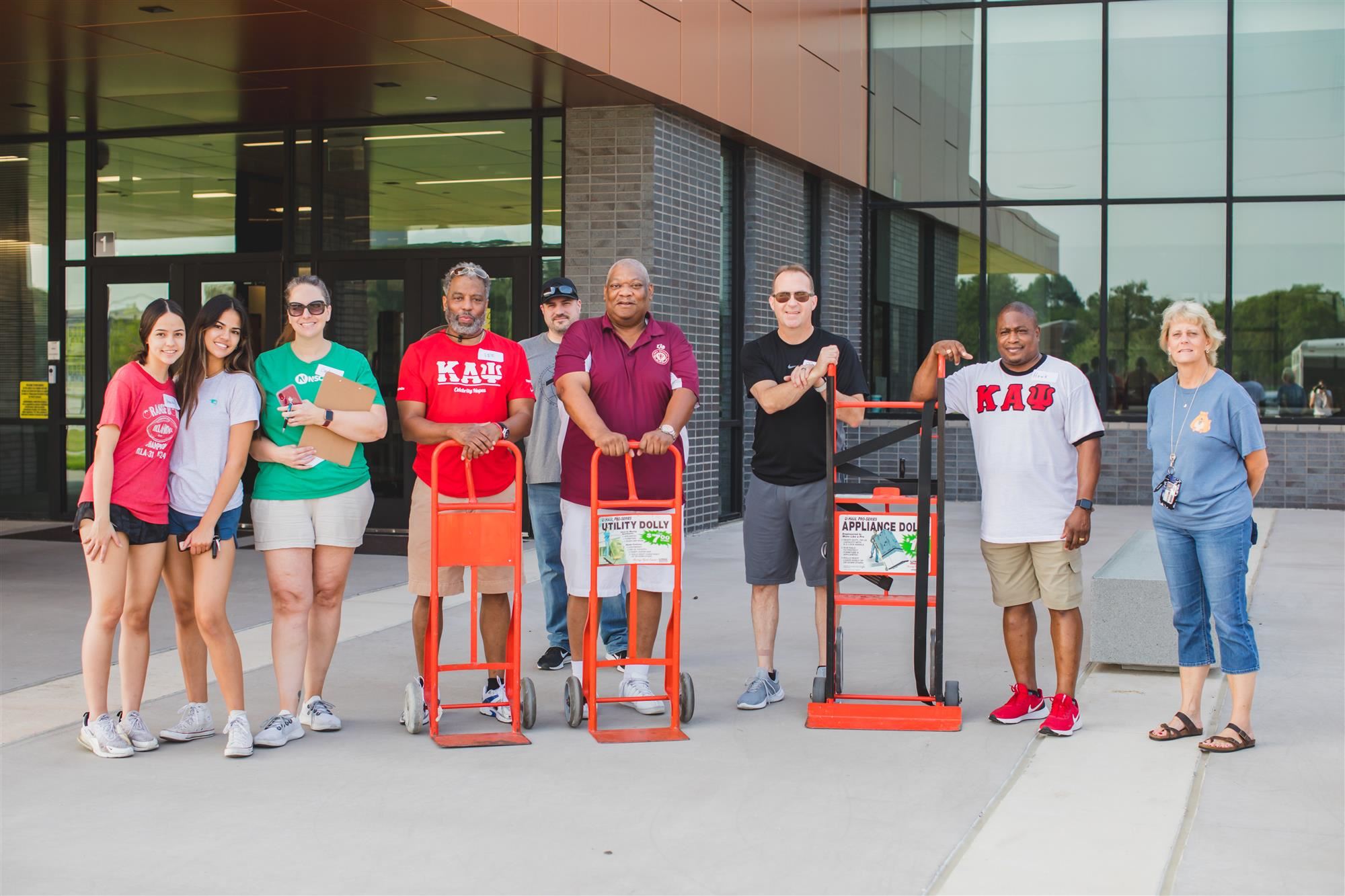 Volunteers deliver backpacks to schools. 